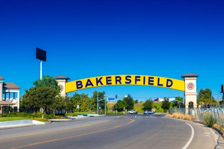 Bakersfield welcome arch spanning a roadway under a clear blue sky
