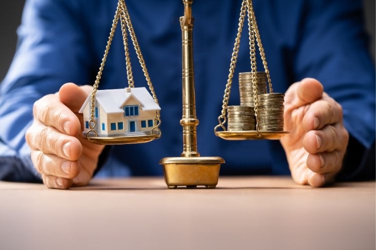 Balanced scales weighing estate assets and financial records