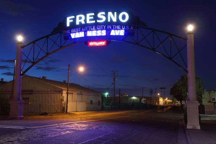 Illuminated Fresno gateway sign on Van Ness Ave at dusk — Tristar private detective in Fresno service area