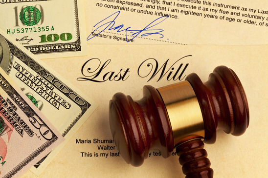 Last will with gavel and cash representing estate and probate issues after family deaths