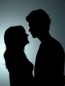 Silhouetted couple facing each other, suggesting suspected infidelity and spouse investigation by Tristar private investigators