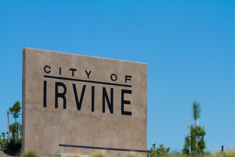 City of Irvine stone sign against blue sky - Tristar private investigator serving Irvine