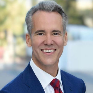 Professional headshot of a smiling male attorney, supporting bankruptcy and foreclosure fraud investigations