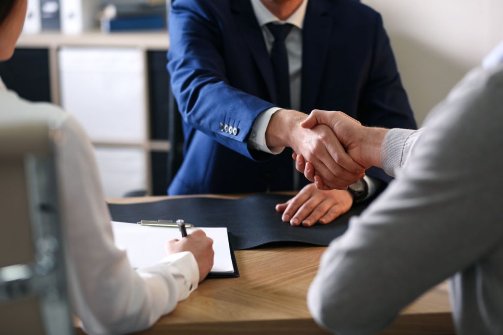 Employment attorney and investigator reviewing former employee information during workplace investigation