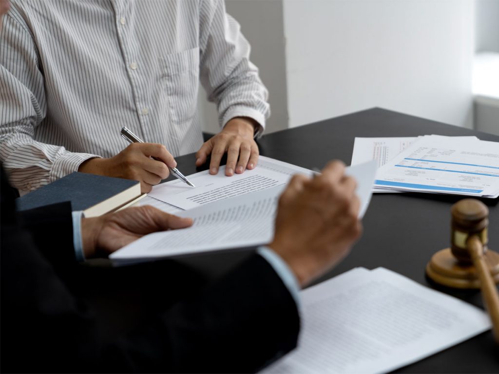 Attorney reviewing legal records to verify information during a civil litigation investigation