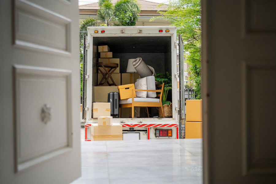 Moving truck outside a residence illustrating a defendant who has relocated before service of process could be completed.