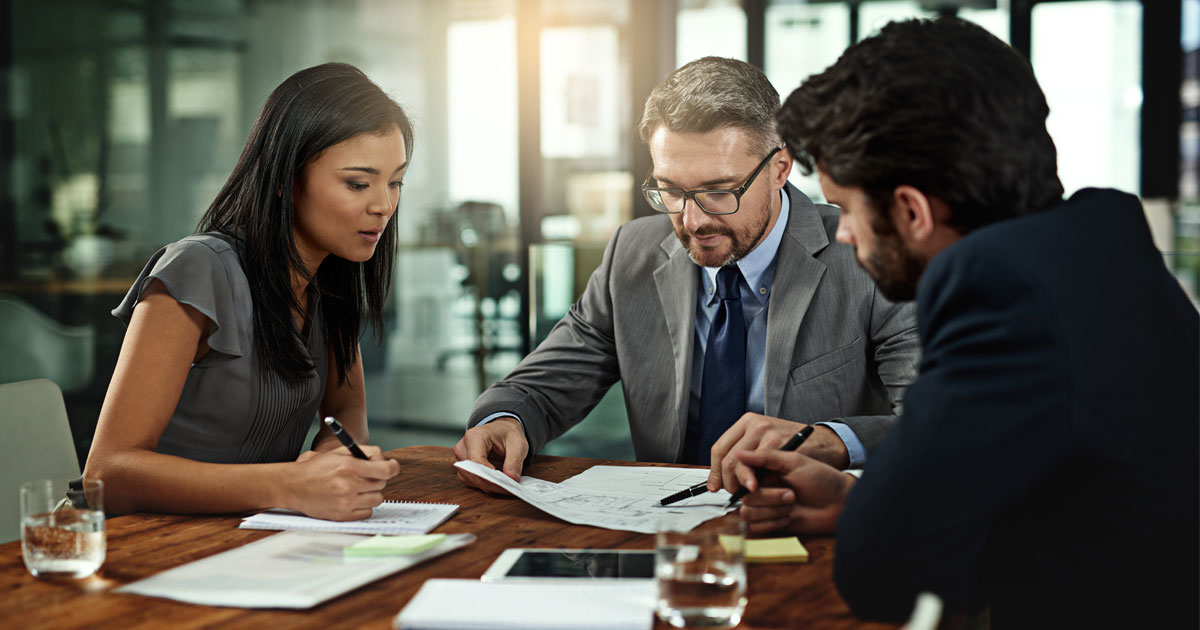 Attorney meeting with an investigator to review a difficult service of process case and litigation strategy.